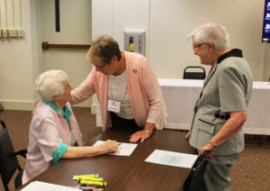 Associate Stephanie Render, center, from Caneyville, Ky., talks with Sister Mary Matthias Ward, as Sister George Mary Hagan looks on.