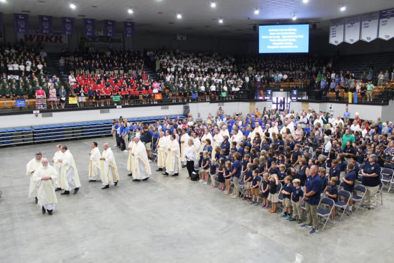 One-third of the priests and deacons in the diocese – those who work closely with the Catholic schools – process in two by two.