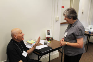 Father Joe Merkt, the facilitator for the morning session, talks with Sister Cheryl Clemons prior to the start of the day.