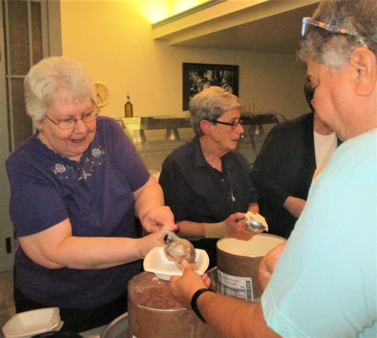Sister Pat Lynch serves “lefty” to Sister Michele Ann Intravia.