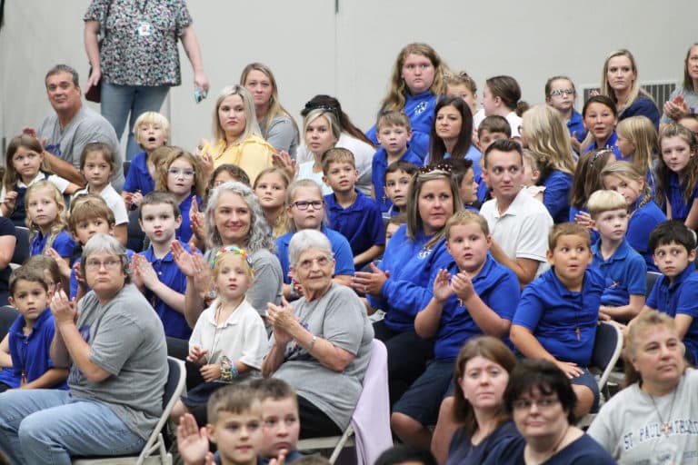 Ursuline Sister Mary Celine Weidenbenner, center in the gray shirt, joins with the students from Mary Carrico Memorial Elementary School in Knottsville to applaud for another school being announced. Sister Mary Celine has been a Catholic school educator since 1967, with the past 15 years at Mary Carrico.