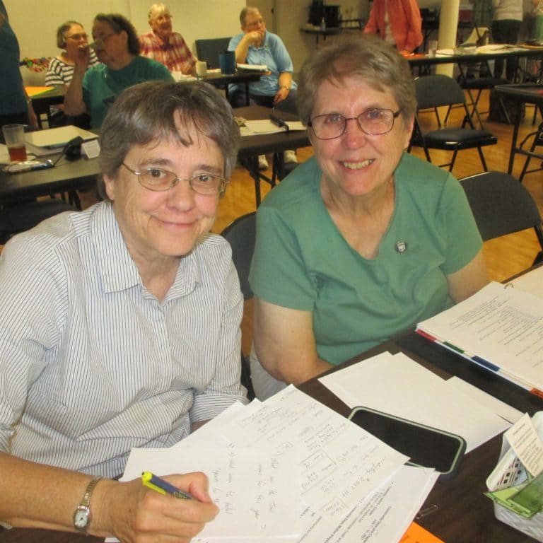 Sister Jacinta Powers, left, and Sister Betsy Moyer take notes during one of the meetings in the Mother Aloysius Room. The two used to live together when they both served in Maple Mount.