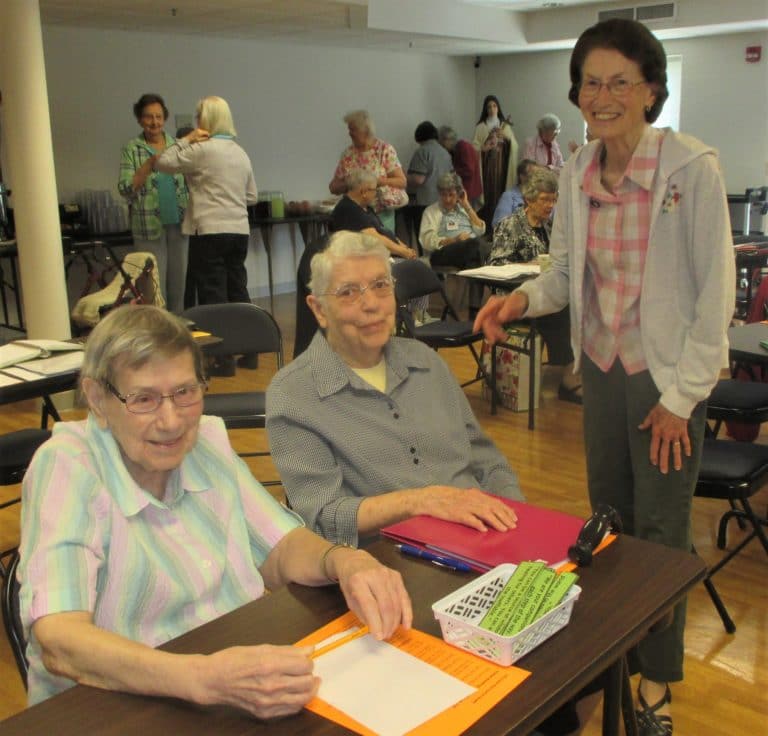 Sister Susanne Bauer, left, Sister Michael Ann Monaghan, center, and Sister Claudia Hayden get ready for the next round of meetings.