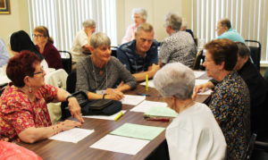 Following the one-on-one discussions, participants returned to their tables to share their thoughts. On the left side of this table were Associates Sara Scully, Cindy Bornander and Ron Bornander, talking with Sisters Mary Diane Taylor, Mary Henning and Rosemary Keough.