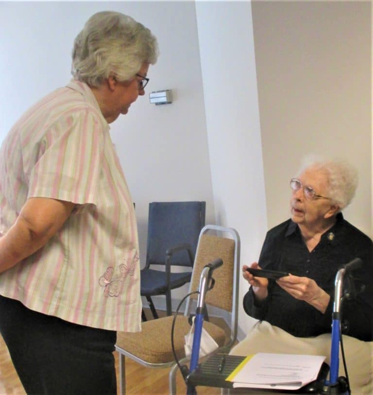 Sister Mary Timothy Bland, standing, and Sister Mary Agnes VonderHaar are in deep discussion about a topic.