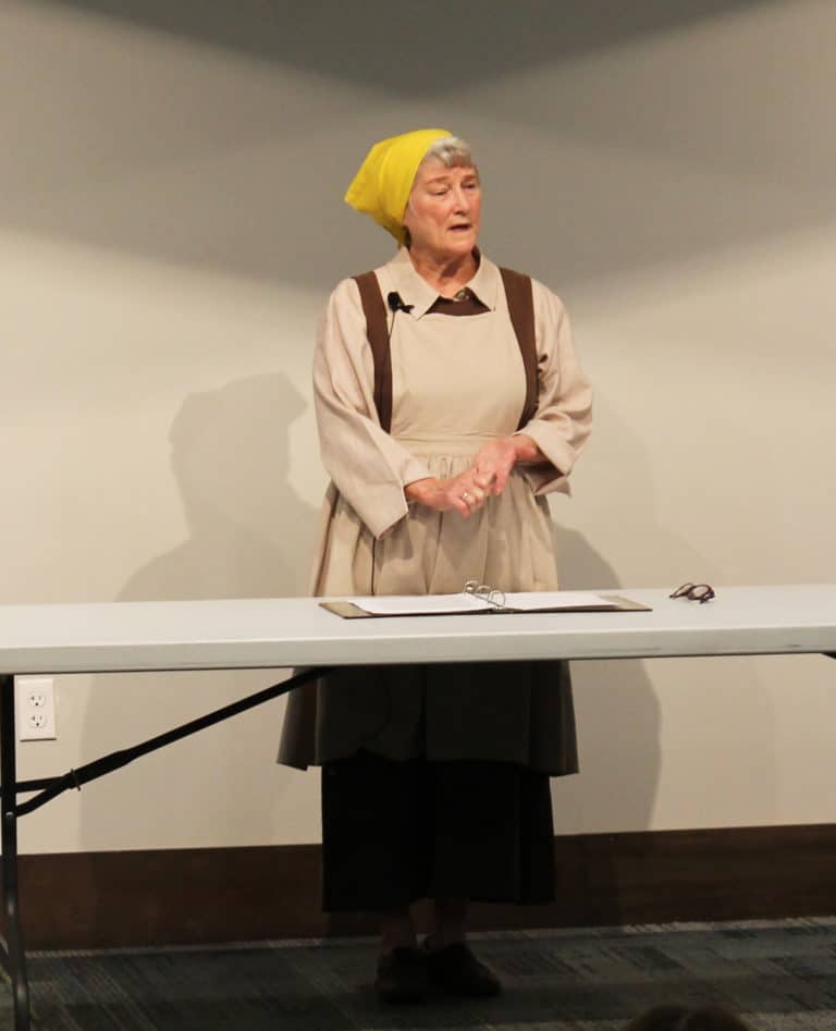 Sister Pam Mueller, dressed as Saint Angela Merici, tells the students gathered that “I knew that God loved me first.” This led her to want to make a difference and to serve where there was a need.