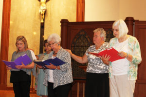 The new associates, all of Owensboro, recite their commitments as their contact companion stands behind them. From left is Jeannie Foster and her contact, Associate Debbie Lanham; Joy Keller and her contact, Sister Martha Keller; and Kathi Skidd, whose contact was also Sister Martha. Kathy made her temporary commitment in 2012, when there were still two commitments, so was making her final commitment this year.