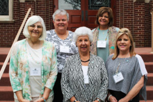 The new associates and their contact companions pose on the chapel steps. In the front row, from left, are Kathi Skidd, Joy Keller and Jeannie Foster; the second row is Sister Martha Keller and Associate Debbie Lanham.
