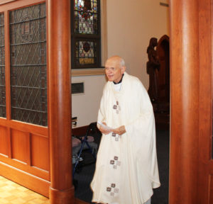Father Joe Merkt, who led discussion in the morning session, prepares to celebrate Mass in the afternoon.