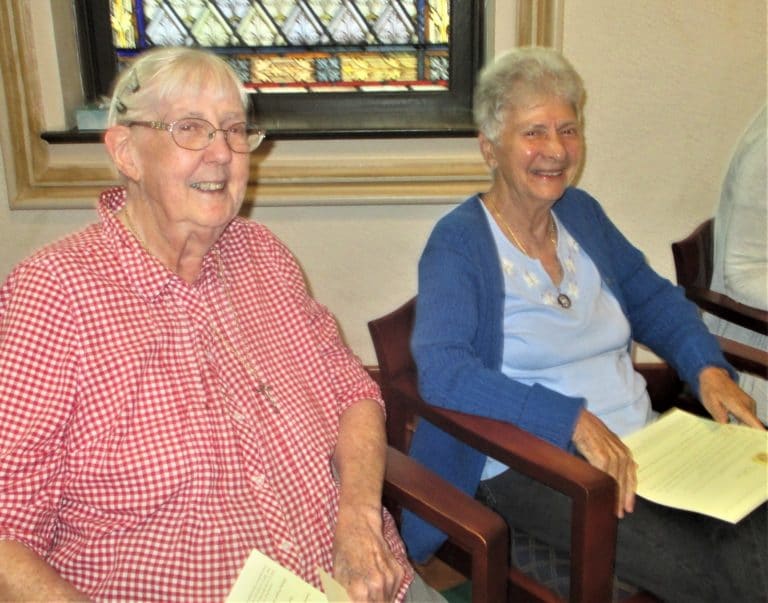 Sister Grace Simpson, left, and Sister Joan Riedley share some smiles in the chapel. Both Sisters serve in Louisville.