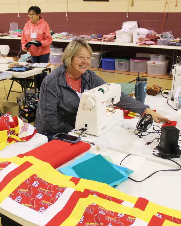 Cindy Murphy works on a St. Louis Cardinals quilt top in Maple Hall.