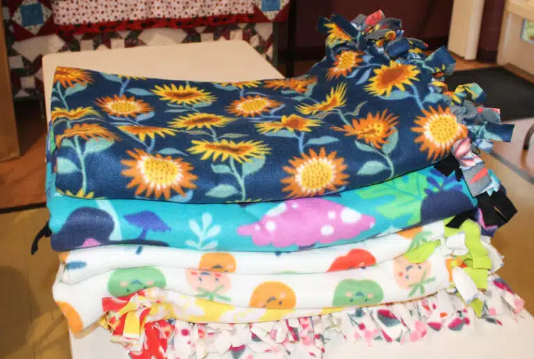 The Sisters completed six blankets in the first few hours of March 2. The goal is for volunteers to make 15 blankets out of fleece. Two yards of fleece are laid on top of the other, and then the sides are cut in strips an inch wide and three inches deep. The strips are then tied together to make blankets.