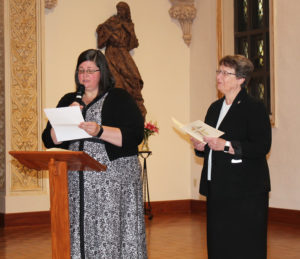 Sister Stephany reads her formula of profession as Sister Amelia Stenger looks on.