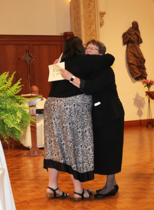 After presenting her formula of profession to Sister Amelia, she received a big hug and a round of applause from the congregation.