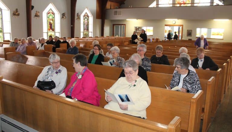 Ursuline Sisters and members of other communities gather in St. Martin Catholic Church for the 11 a.m. celebration. In the front row are three Ursuline Sisters celebrating jubilees – Sister Ruth Gehres, left, 70 years; Sister Sharon Sullivan, center, 40 years; and Sister Rose Jean Powers, 60 years.