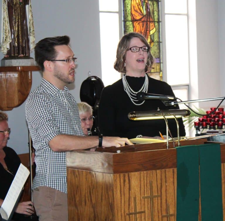 Jacob Hein and Heather Greene, both music ministers in the diocese, lead the singing of “Center of My Life” to open the ceremony.