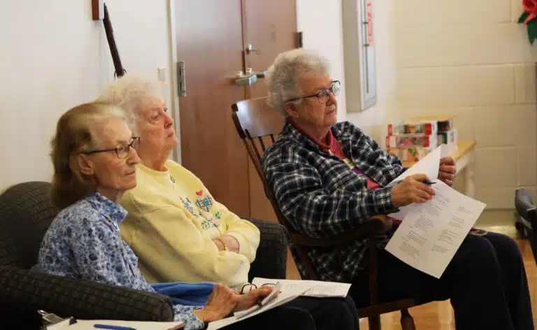 From left, Sister Claudia Hayden, Sister Vivian Bowles, and Sister Michele Morek listen to Brother Zachary lead the opening prayer. From left, Sister Claudia Hayden, Sister Vivian Bowles, and Sister Michele Morek listen to Brother Zachary lead the opening prayer.