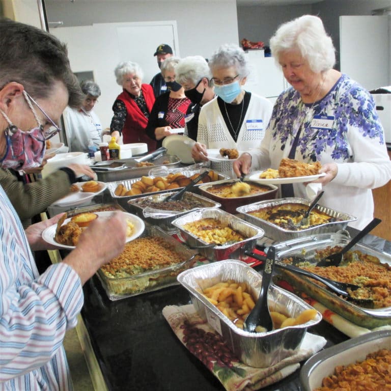 The lunch prepared by the Serra Club is always beautiful and delicious. From left, Ursuline Sisters Sharon Sullivan, Luisa Bickett, Francis Louise Johnson, Betsy Moyer, Pam Mueller, Ann Patrice Cecil and Vivian Bowles prepare to enjoy their lunch.