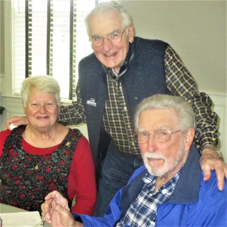 Sister Suzanne Sims spends times with with Serra Club members Ron Sullivan (standing) and Bob Slack.