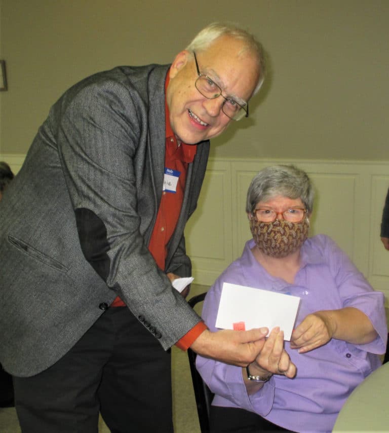 Sister Mary McDermott is a happy winner of a prize from the emcee – Serra club member Ernie Taliaferro.
