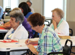 Sister Susan Mary Mudd takes notes as Sister Luisa Bickett, left, and Sister Marie Joseph Coomes follow along with the discussion.