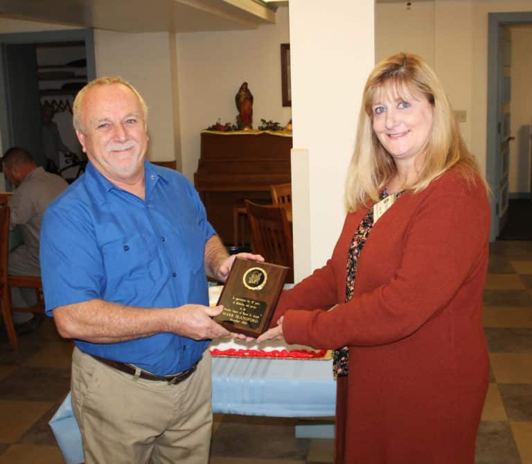 Mark Blandford receives a plaque congratulating him on his 47 years of service to the Mount from Dee Dee Jackson, director of human resources.