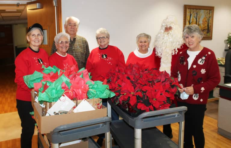 The Western Kentucky Associates gather with their wagons full of gifts on Dec. 3, 2022. From left are Risë Karr, Betty Boren, Mike Sullivan, Lois Bell, Elaine Wood (as Mrs. Claus), Santa Claus and Sid Mason. Once again, John Wood was nowhere to be found while Santa was on the premises.