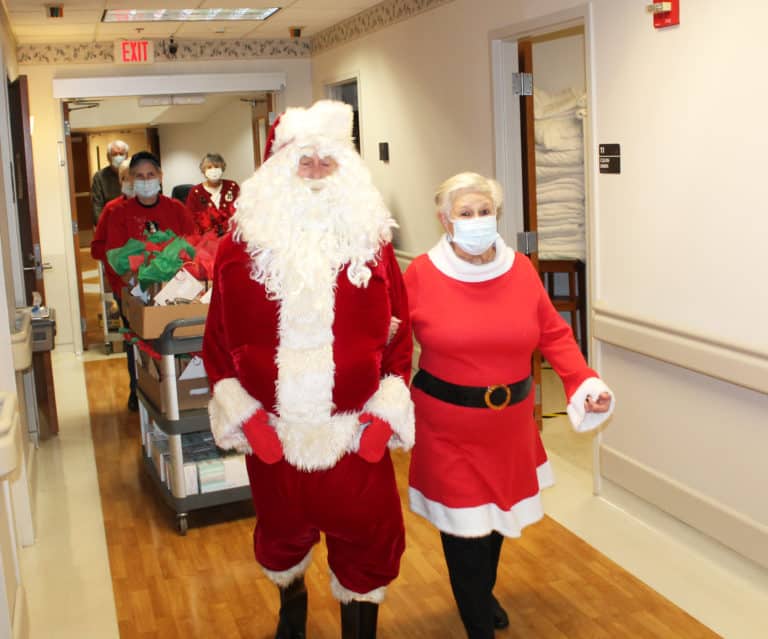 Santa and his elves begin making their way down the hallway in Saint Joseph Villa.