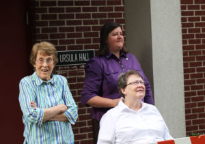 Sister Elaine Burke, left, Sister Monica Seaton, right, and Sister Amelia Stenger, seated, were among those watching the limbs come down.