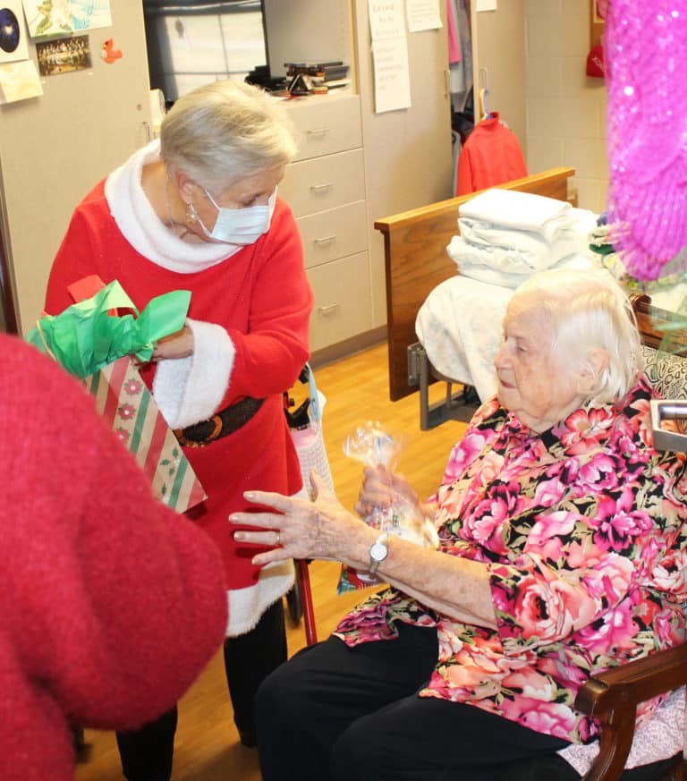 Sister Catherine Kaufman took a break from doing her laundry to welcome Santa and his elves.