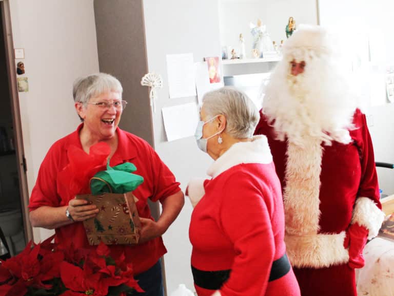 Sister Emma Anne Munsterman can’t hide her enthusiasm for her visit with Santa and Mrs. Claus.