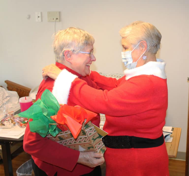 Sister Karla Kaelin, left, gets a hug from Elaine Wood. Sister Karla served in Benton and Mayfield from 2003-08, and gathered with the Western Kentucky Associates during that time.