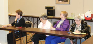 From left, Ursuline Sisters Mary Henning, Luisa Bickett, Rebecca White and Mary McDermott follow Sister Catherine Marie’s talk. She informed them the room they were in was the choral room when she began teaching music at the Academy.