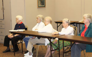 The first graduate of Mount Saint Joseph Academy in 1880 was Anna Johnson, Sister Catherine Marie said, noting that she was a relative of Sister Francis Louise Johnson, seated at right. (Anna was the sister of Sister Francis Louise’s grandfather.) The other Ursuline Sisters listening, from right, are Sisters Grace Swift, Alfreda Malone, Mary Gerald Payne and Mary Matthias Ward, director of the Retreat Center.