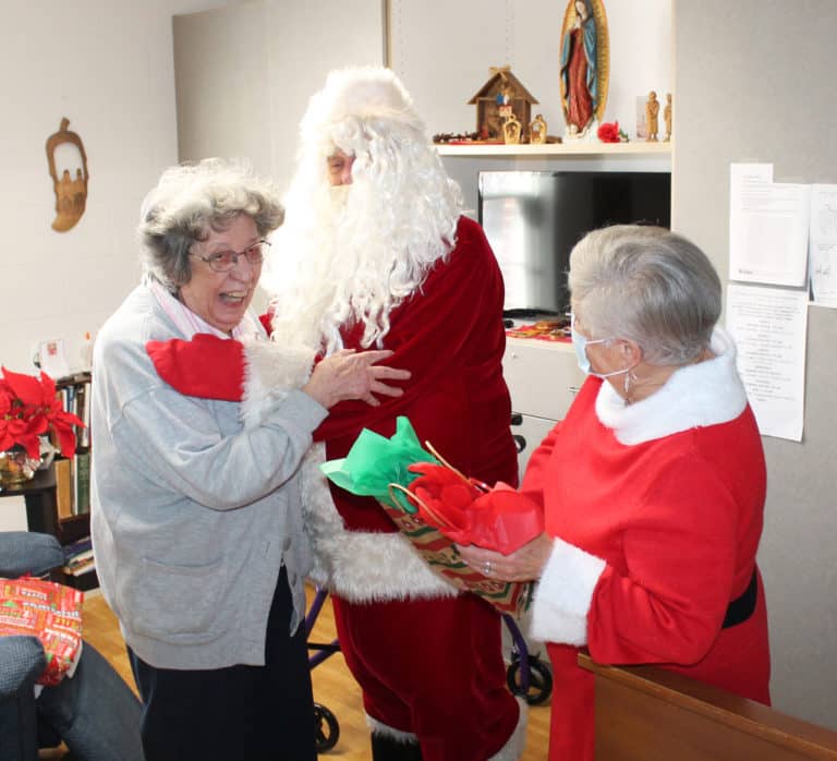 Sister Luisa Bickett can’t contain her joy as she gets a hug from Santa. Sister Luisa will celebrate 75 years as a Sister in 2023.