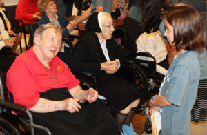 Sister Celine Leeker talks with one of the youngest camp members, as Sister Emma Cecilia Busam chats in the background.