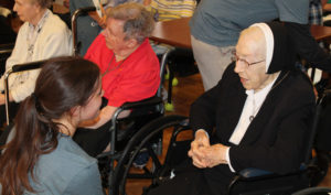 Sister Emma Cecilia Busam chats with this camp member who has visited the Mount several times. Sister Emma Cecilia is celebrating 75 years as a sister this year.