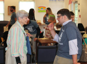 Sister Sheila Anne Smith talks with one of the counselors from the camp about the schools the sisters staffed in New Mexico.