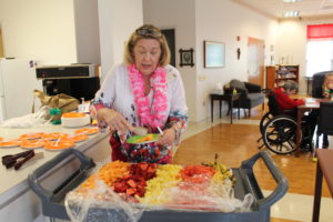 Debbie Dugger serving up some fresh fruit!