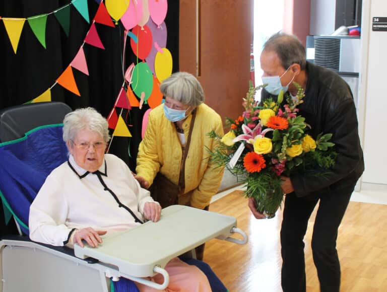 Barbara Montgomery, Sister Marie’s sister-in-law, and her nephew Wayne Pickrell welcome Sister Marie with flowers.