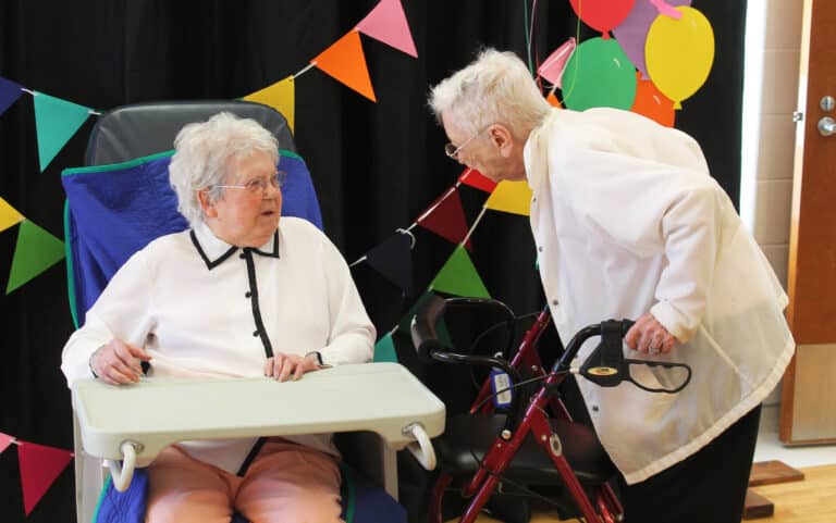 Sister Marie, left, talks with Sister Marie Bosco Wathen, who at 98 years old is the third oldest Sister in the community. Sister Naomi Aull is the second.