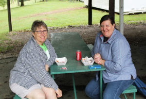 Sister Betsy Moyer, left, and Sister Monica Seaton finish their lunch under the shelter.
