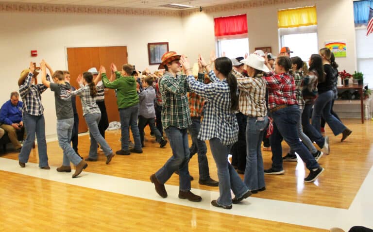 The fifth- through eighth-graders combine to dance the Virginia Reel.