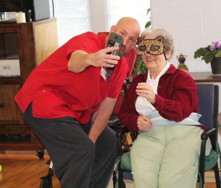 Sister Rose Karen Johnson takes a selfie with James, one of the staff members of Almost Family. Sister Rose Karen Johnson takes a selfie with James, one of the staff members of Almost Family.
