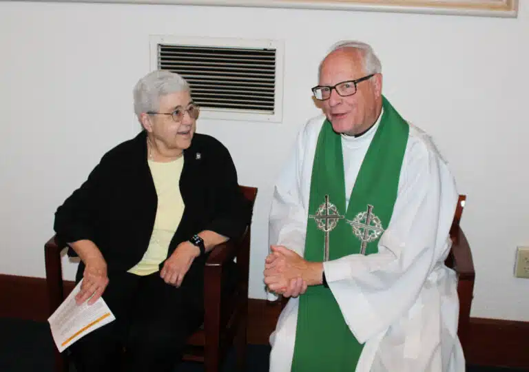 Sister Ann McGrew, who concluded her term as a councilor, speaks with Father John Vaughan, who concelebrated the Mass. Sister Ann McGrew, who concluded her term as a councilor, speaks with Father John Vaughan, who concelebrated the Mass.