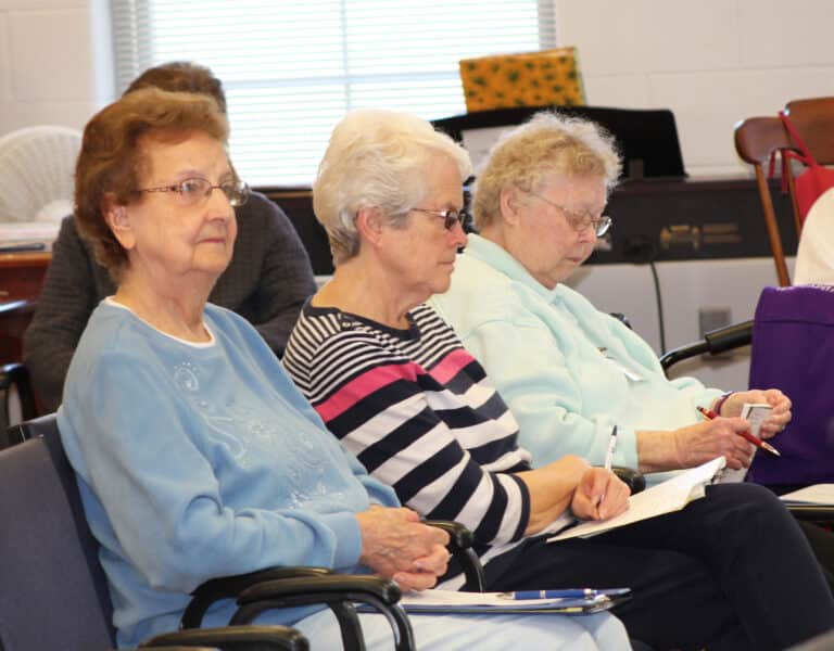 Following Father Mullen’s talk are, from left, Sisters Susan Mary Mudd, Barbara Jean Head and Marie Joseph Coomes. Father Mullen gives retreats, parish missions and serves as a spiritual director in addition to his other duties.