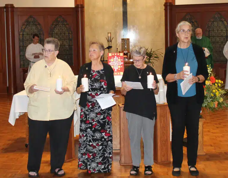 The new Leadership Council reads from Saint Angela Merici’s First Council, “We regard ourselves as ministers and servants, knowing that we have more need to serve than you have to be served by us.” From left are Sister Sharon Sullivan, Sister Alicia Coomes, Sister Judith Nell Riney, and Sister Larraine Lauter. The new Leadership Council reads from Saint Angela Merici’s First Council, “We regard ourselves as ministers and servants, knowing that we have more need to serve than you have to be served by us.” From left are Sister Sharon Sullivan, Sister Alicia Coomes, Sister Judith Nell Riney, and Sister Larraine Lauter.