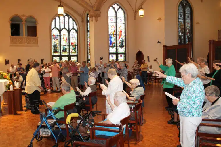 As the celebration ended, the congregation rose and extended their hands toward the new Leadership Council and offered them a blessing. It included, “We, their Sisters, surround them with the promise of our prayerful support as they generously give their lives in wholehearted service,” and concluded with “May they know themselves as worthy bearers of your Word and daughters of Saint Angela so that, in all things, you alone may be glorified.” As the celebration ended, the congregation rose and extended their hands toward the new Leadership Council and offered them a blessing. It included, “We, their Sisters, surround them with the promise of our prayerful support as they generously give their lives in wholehearted service,” and concluded with “May they know themselves as worthy bearers of your Word and daughters of Saint Angela so that, in all things, you alone may be glorified.”