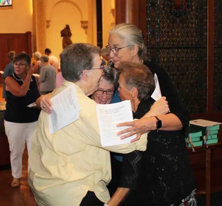 The new Council gathers for a playful hug following the ceremony. The new Council gathers for a playful hug following the ceremony.