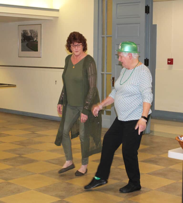 Ursuline Associate Doreen Abbott shows Sister Suzanne Sims some Irish dance steps during dinner. Doreen is the coordinator of Ursuline Partnerships at Mount Saint Joseph.